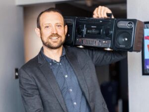 Paul Hunton poses with a radio